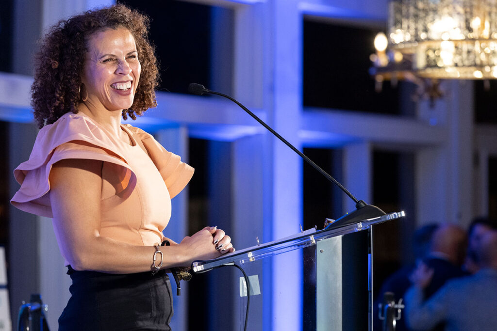 woman at podium at NVTC data center awards