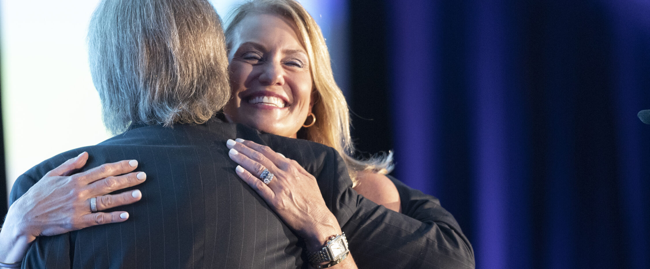 Jennifer Taylor hugging NVTC Board Chair Greg Baroni