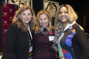 Photo of three women at the networking portion of the cybersecurity event