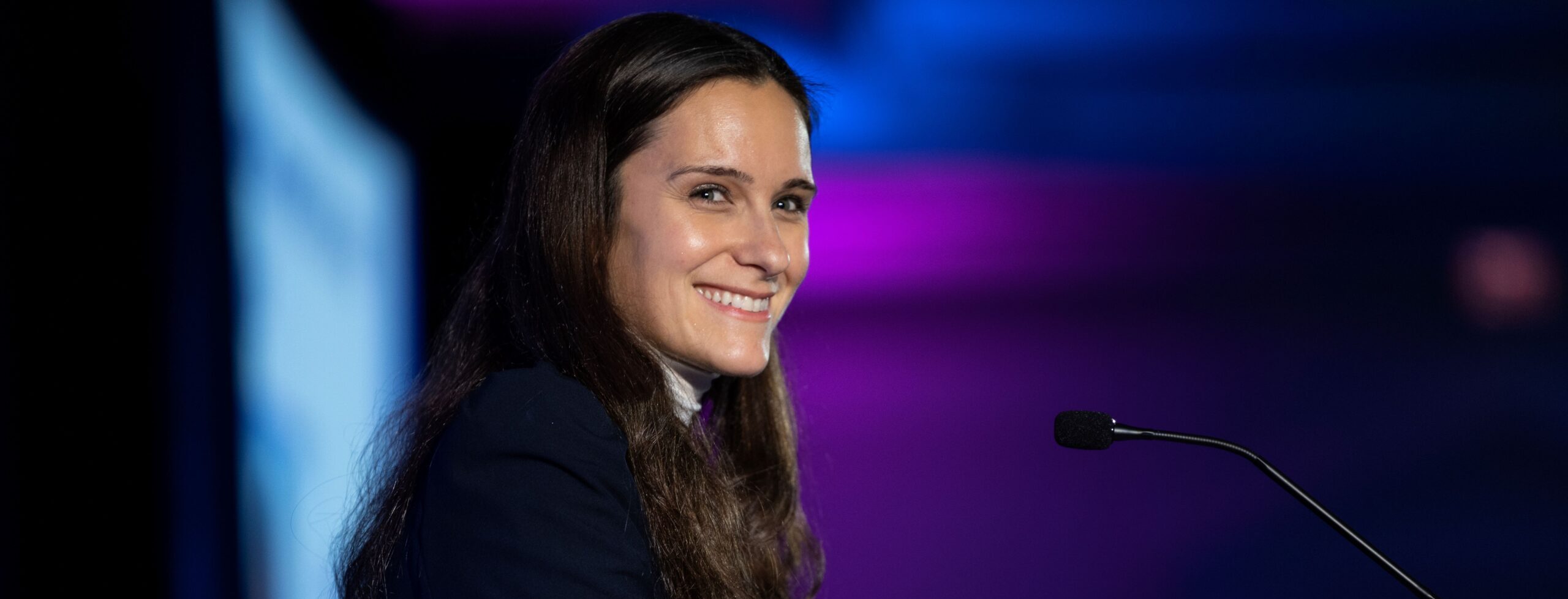 Woman at the podium smiling at 2023 CFO Awards