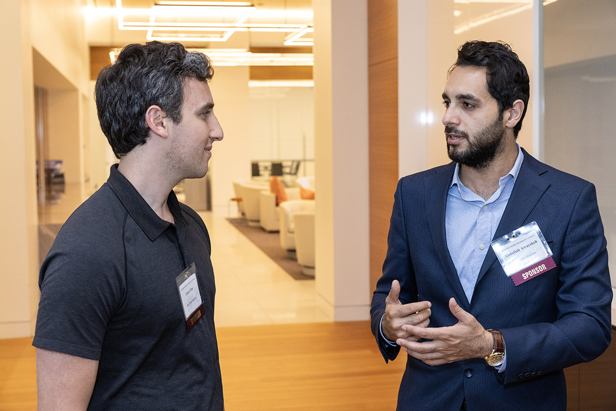 Two men talking to each other at an event