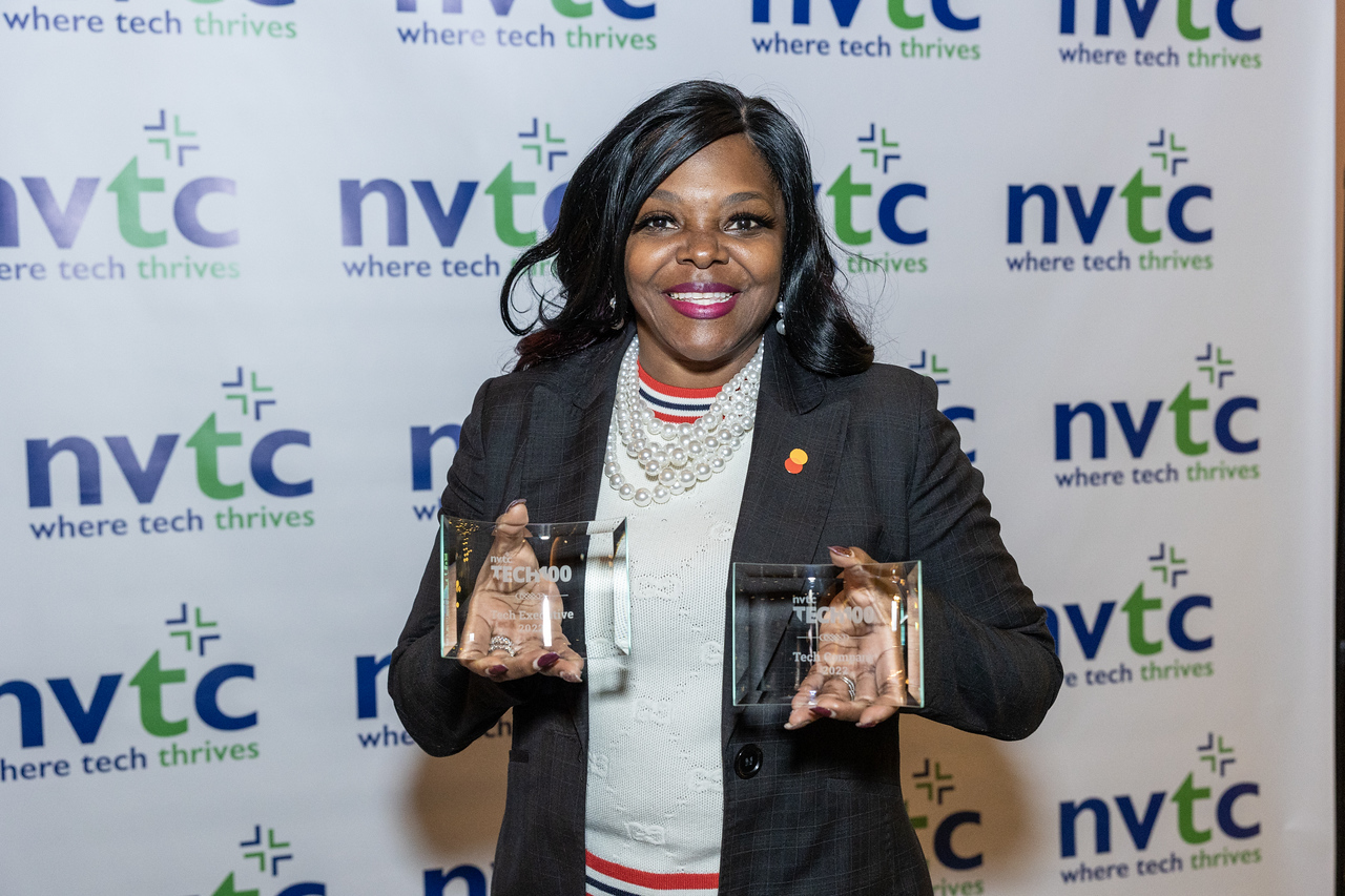 Black woman with two Tech 100 awards in her hands