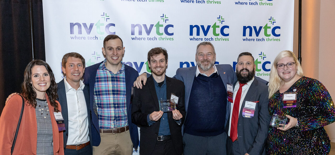 Group of people holding Tech 100 awards