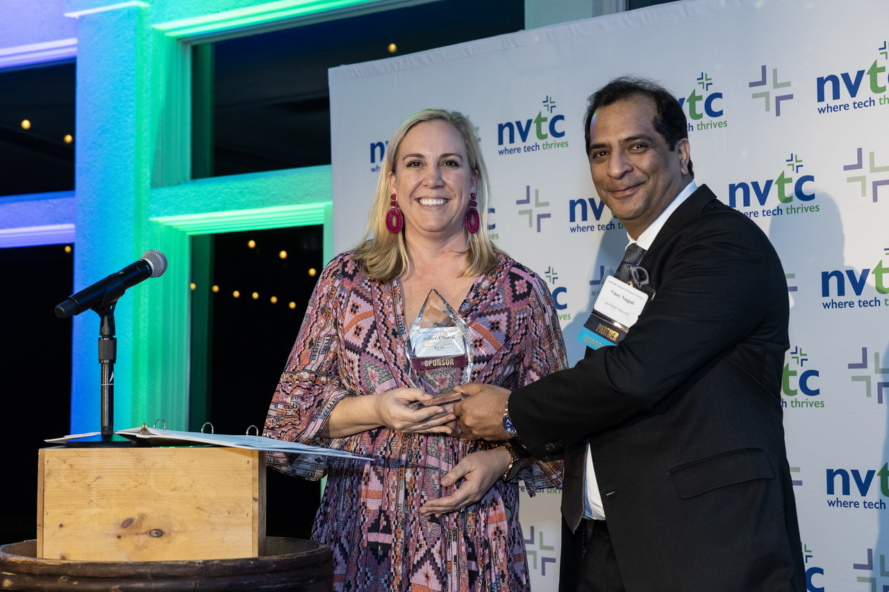 A woman receiving a Data Center Award from Vinay from Interglobix